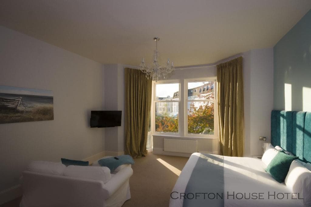 Bright guest room with seating at Crofton House Hotel